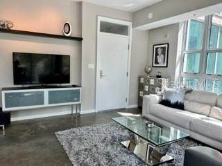 1350 Main Street, Unit 204 Sarasota, FL 34236 - Photo 6 of 22 a living room with furniture and a flat screen tv