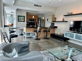 1350 Main Street, Unit 204 Sarasota, FL 34236 - Photo 7 of 22 a living room with furniture and a flat screen tv