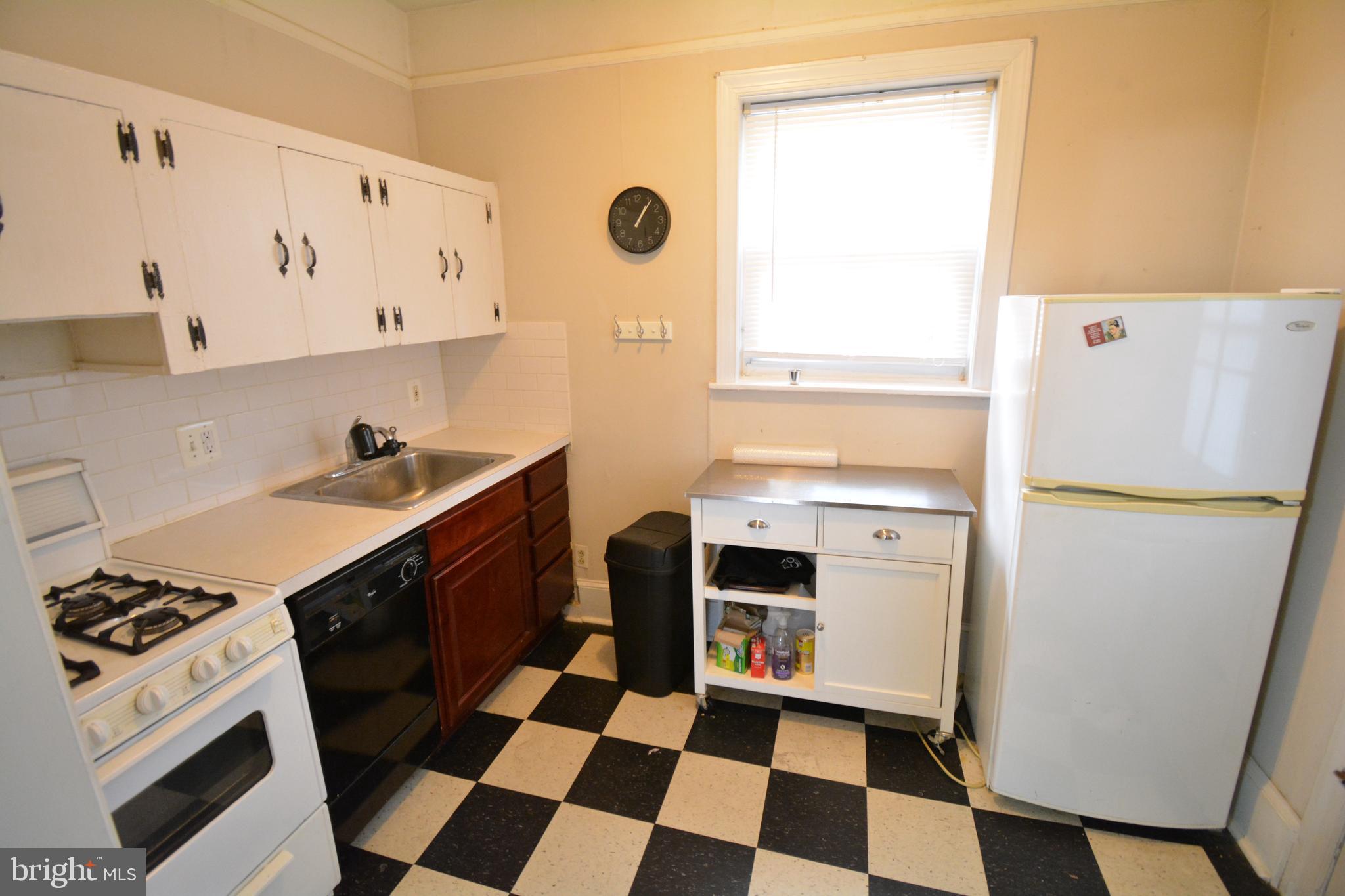 235 West Rittenhouse Street, Unit 1B Philadelphia, PA 19144 - Photo 5 of 9 a kitchen with a stove a refrigerator and a sink