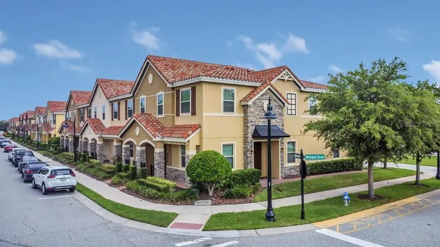 a front view of a house with a garden and trees