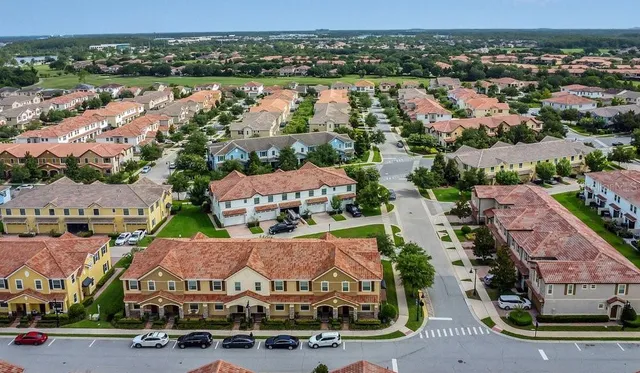 an aerial view of a house with outdoor space lake view and a large building