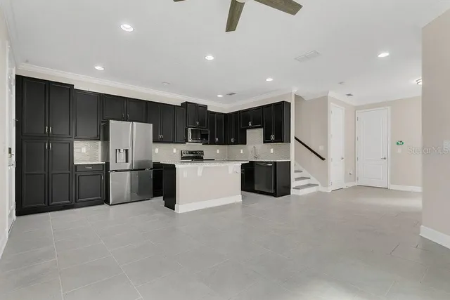 a kitchen with stainless steel appliances a refrigerator and a sink