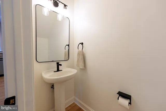 a bathroom with a sink and mirror