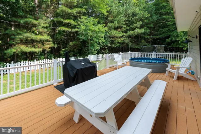 a view of a deck with two chairs and wooden floor