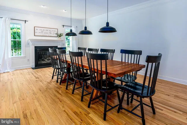 a view of a dining room with furniture wooden floor and chandelier