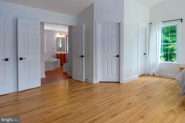 a view of empty room with wooden floor