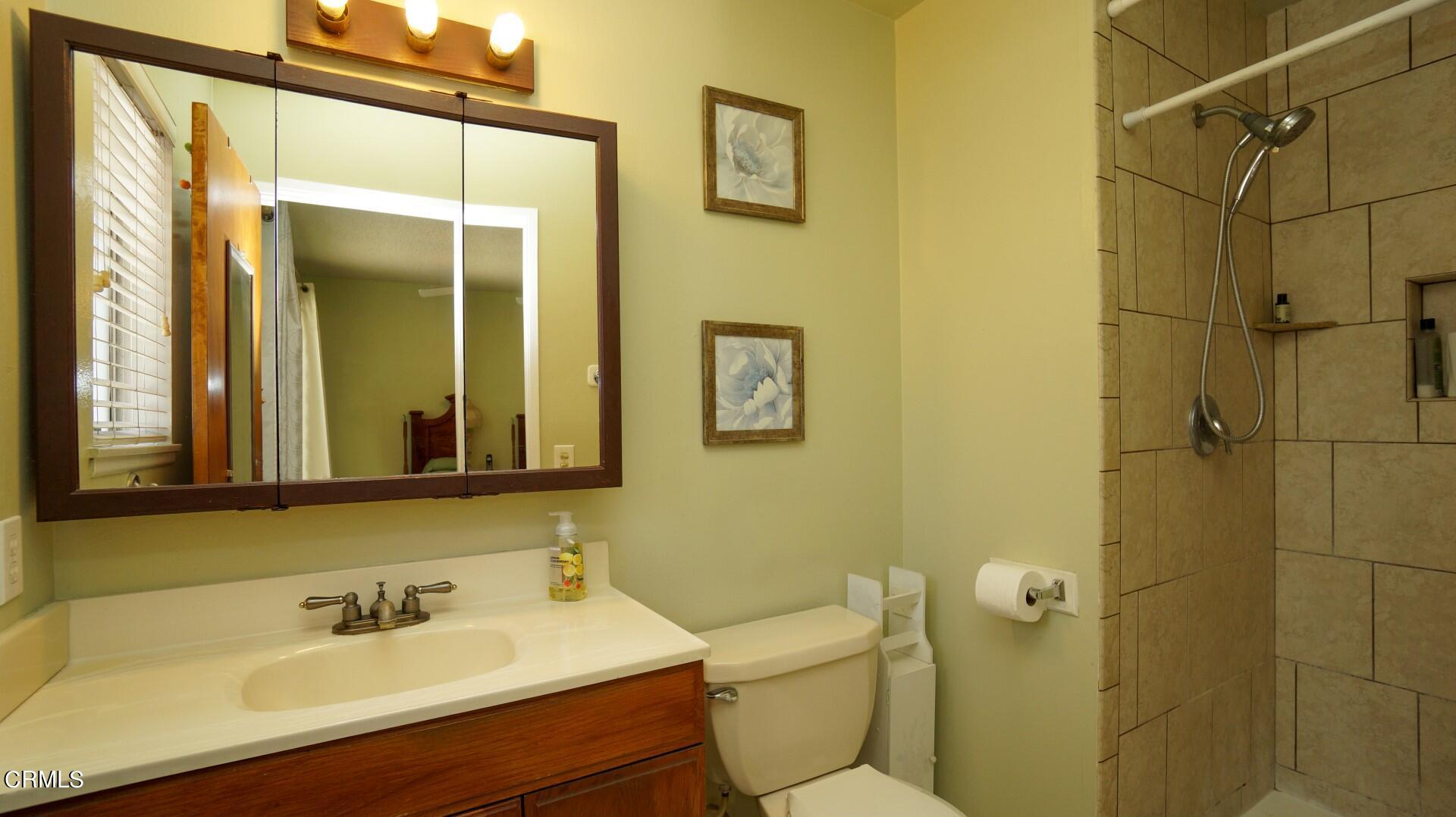 1121 Yale Street Oxnard, CA 93033 - Photo 12 of 22 a bathroom with a sink mirror toilet and shower
