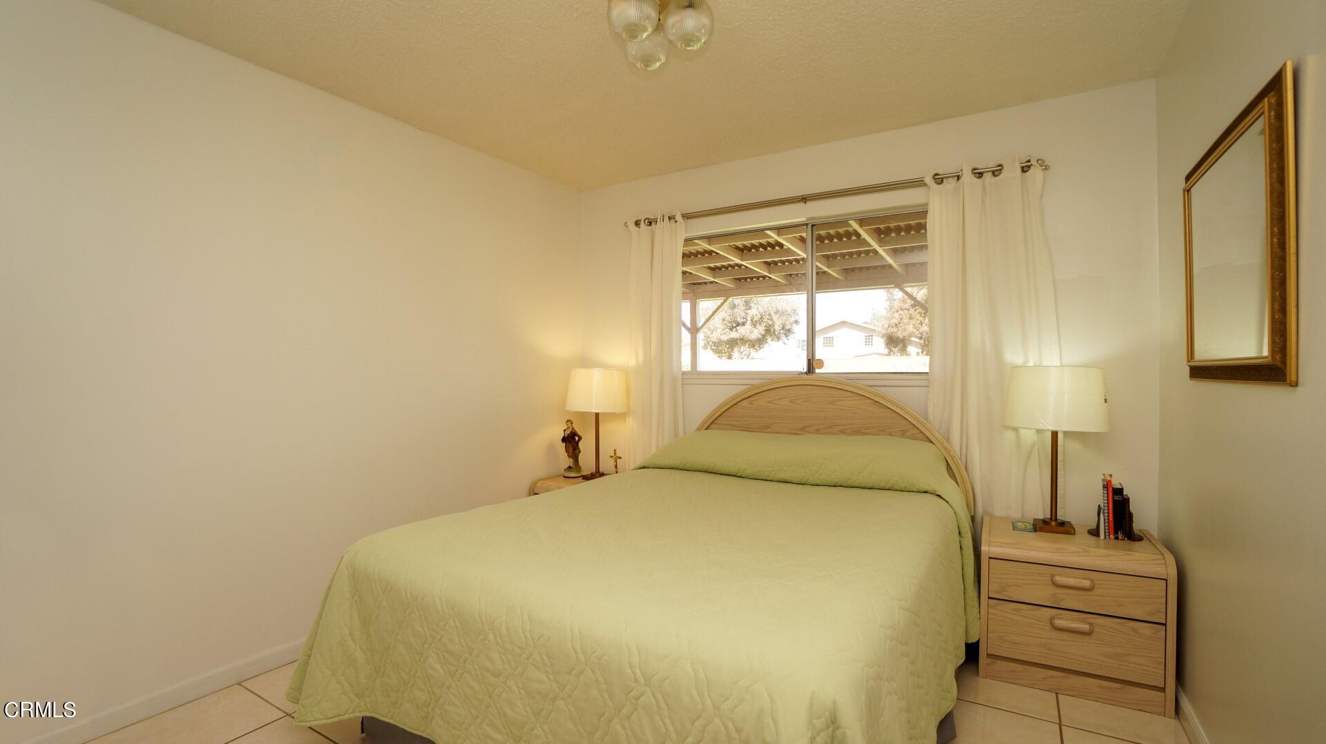 1121 Yale Street Oxnard, CA 93033 - Photo 13 of 22 a bedroom with a bed and a window