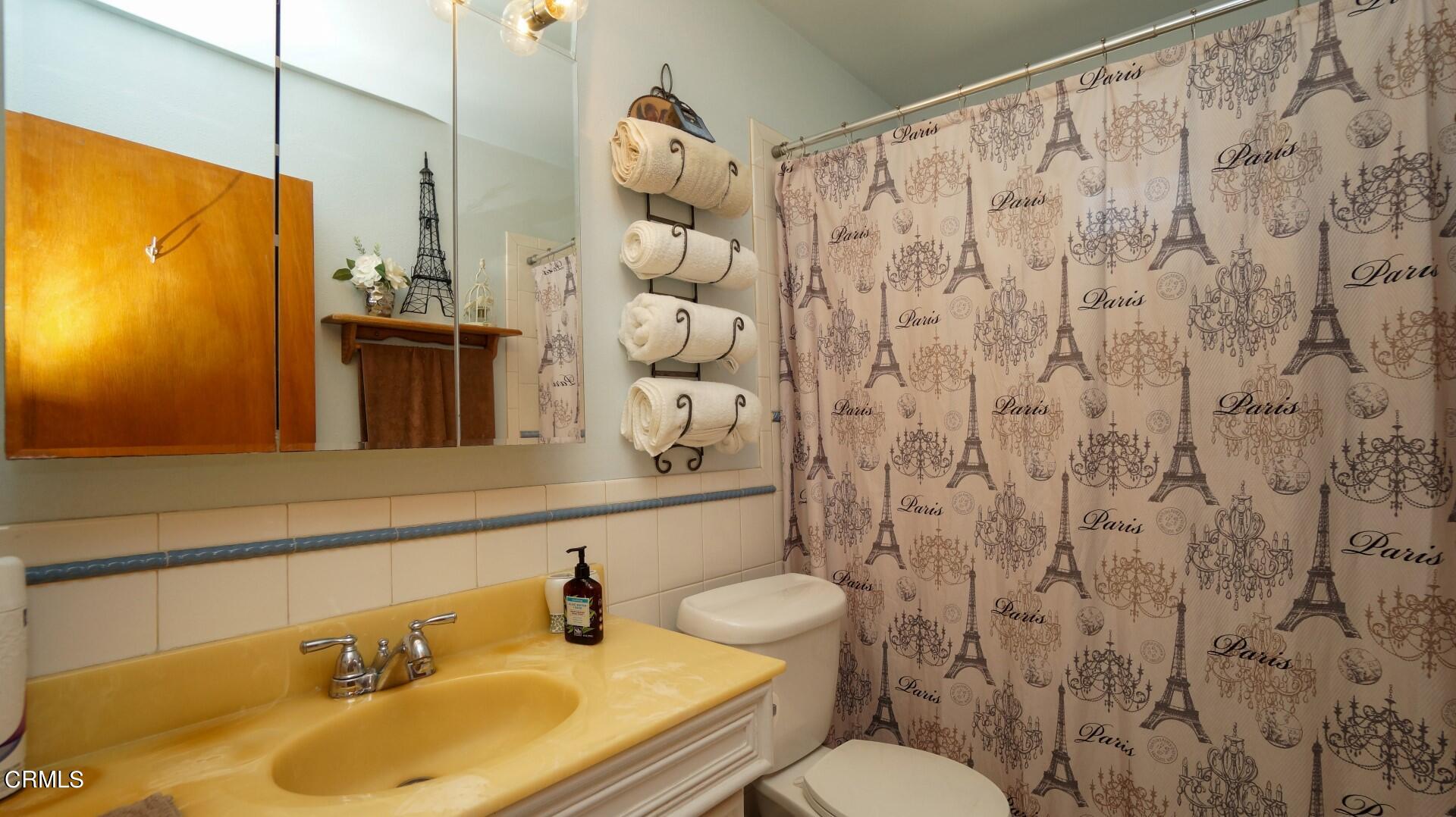 1121 Yale Street Oxnard, CA 93033 - Photo 15 of 22 a bathroom with a sink and a mirror