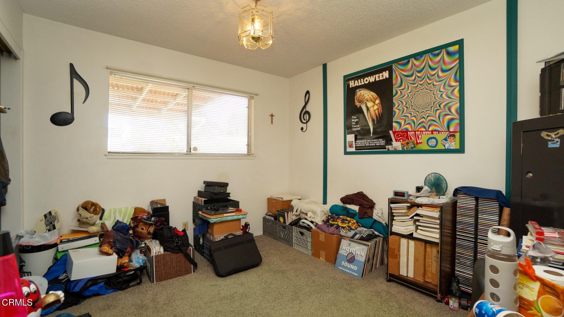 1121 Yale Street Oxnard, CA 93033 - Photo 16 of 22 a room with furniture a chandelier and a window