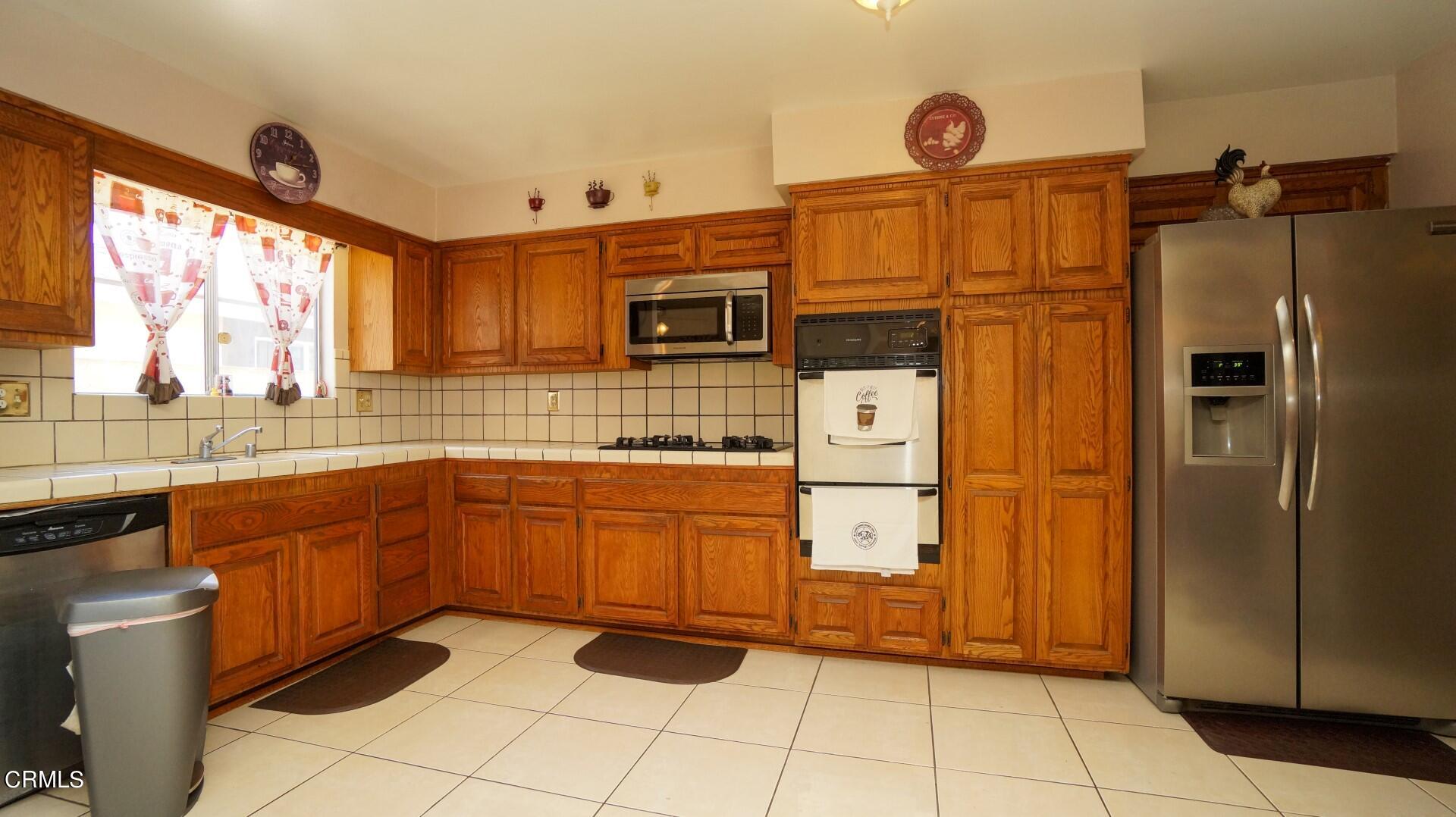 1121 Yale Street Oxnard, CA 93033 - Photo 4 of 22 a kitchen with stainless steel appliances granite countertop a refrigerator and a sink