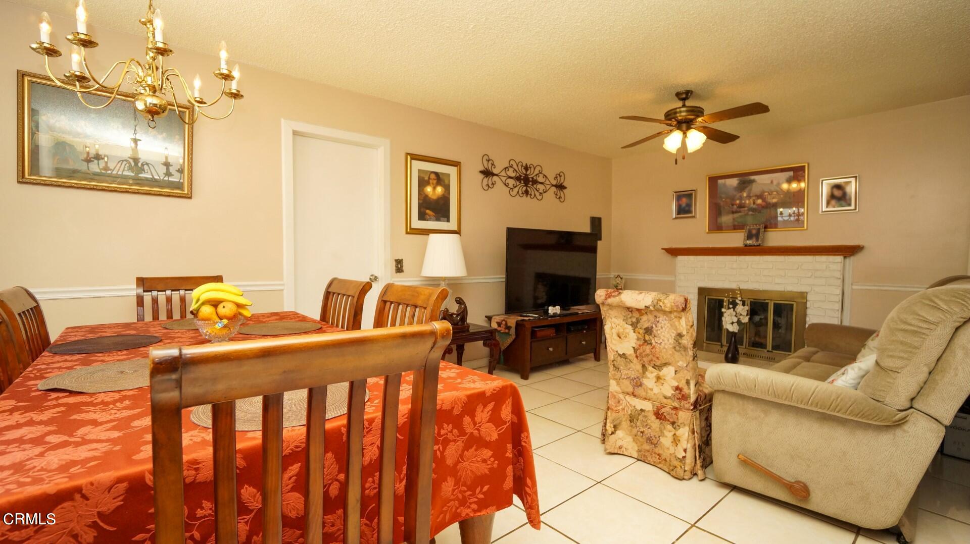 1121 Yale Street Oxnard, CA 93033 - Photo 6 of 22 a living room with furniture a fireplace and a chandelier