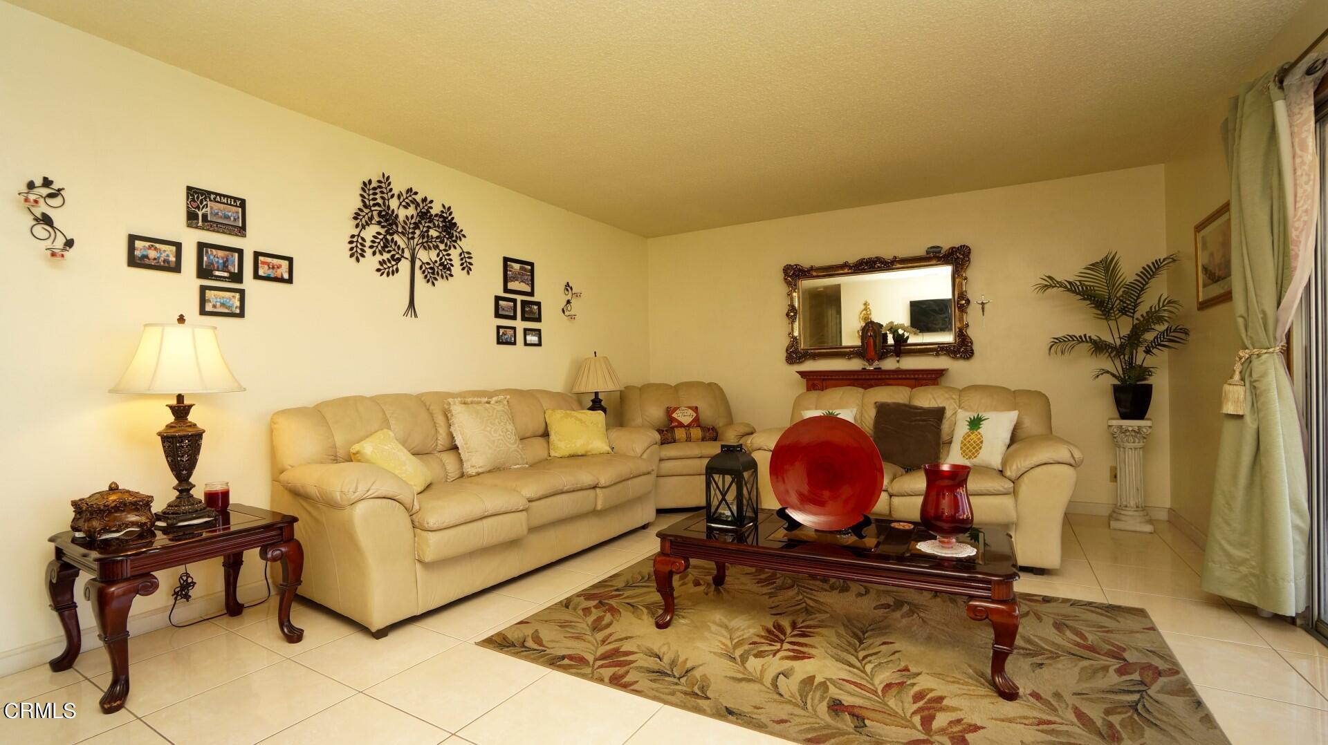 1121 Yale Street Oxnard, CA 93033 - Photo 9 of 22 a living room with furniture and a floor to ceiling window