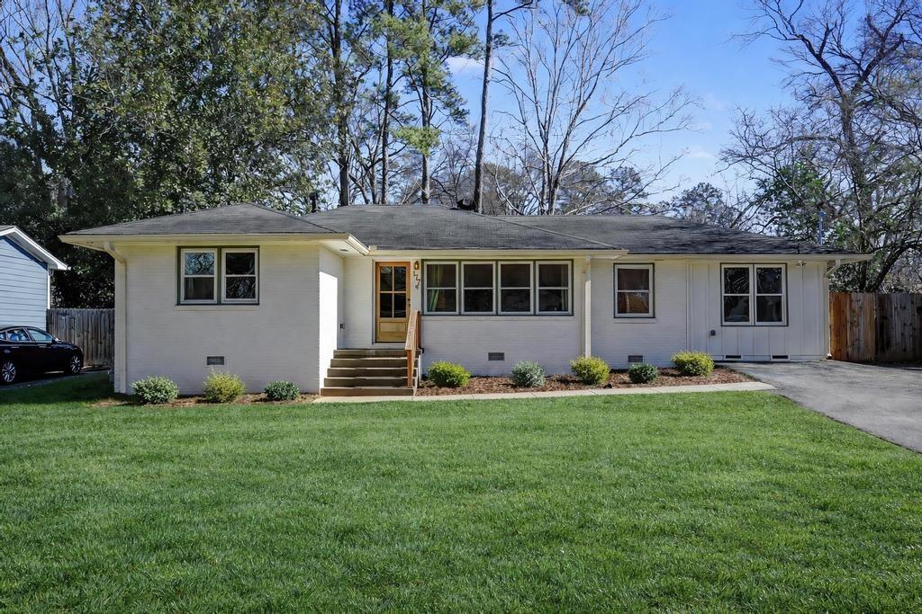 a front view of house with yard and green space