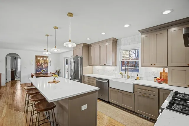 a view of a kitchen counter space a sink appliances and cabinets