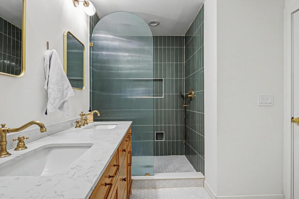 177 Kirkpatrick Drive Southwest Marietta, GA 30064 - Photo 20 of 37 a bathroom with a granite countertop sink a mirror and shower