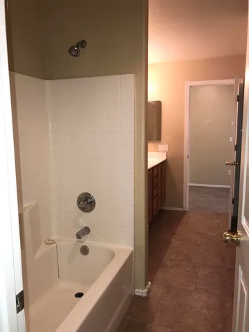 a bathroom with a tub and shower
