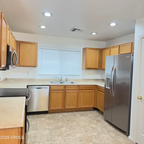 a kitchen with stainless steel appliances granite countertop a granite counter tops and a refrigerator