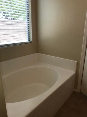 a white bath tub sitting in a bathroom
