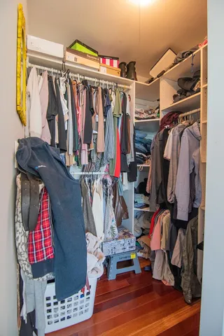 a view of walk in closet with clothes