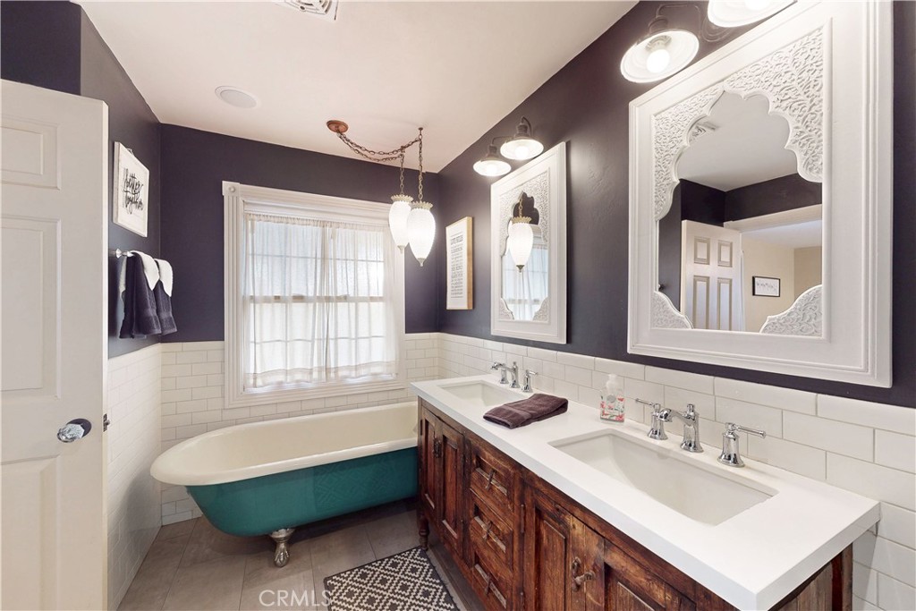 1473 Willow Road Nipomo, CA 93444 - Photo 28 of 52 a bathroom with a tub double vanity sink and mirror