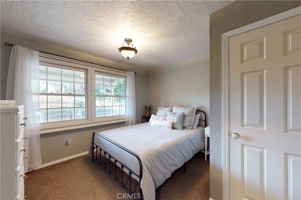 1473 Willow Road Nipomo, CA 93444 - Photo 30 of 52 a bedroom with a bed and a window