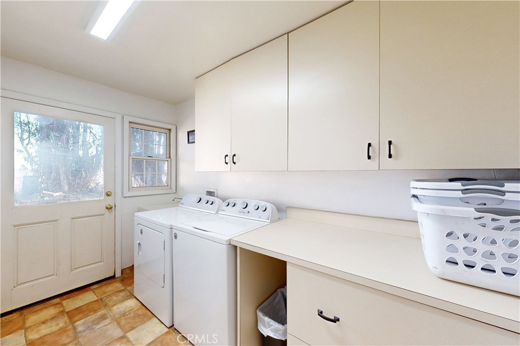 1473 Willow Road Nipomo, CA 93444 - Photo 37 of 52 a utility room with cabinets washer and dryer