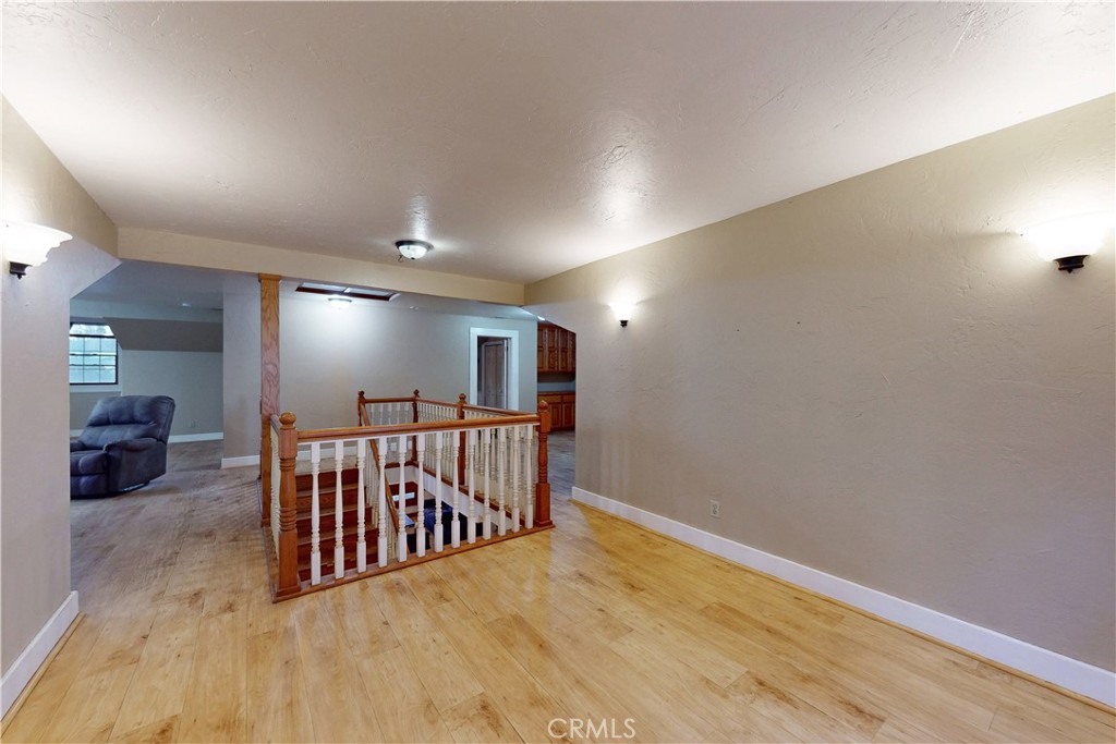 1473 Willow Road Nipomo, CA 93444 - Photo 41 of 52 a view of a hallway with wooden floor and a potted plant
