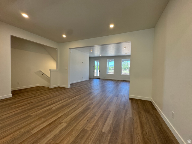 1476 North 1875 West, Unit 152 Layton, UT 84041 - Photo 7 of 20 Spacious open-concept living area featuring wood-finish flooring, recessed lighting, and white baseboards