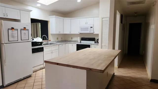 a kitchen with a sink a stove and refrigerator