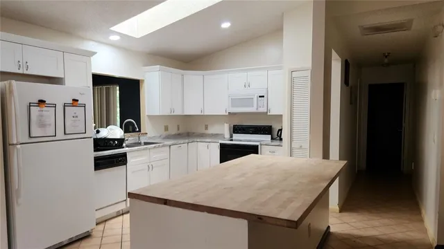 a kitchen with a refrigerator stove and sink