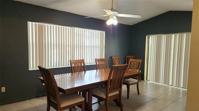 a view of a dining room with furniture and window