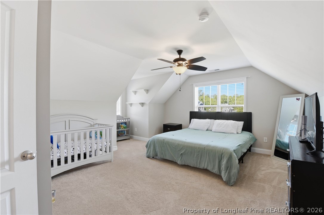 140 Birch Avenue Spring Lake, NC 28390 - Photo 43 of 49 a bedroom with a bed and a chandelier
