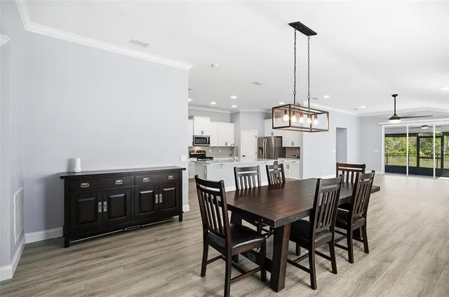 a view of a dining room with furniture window and wooden floor