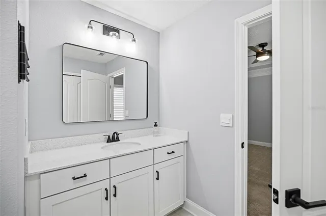 a bathroom with a double vanity sink and mirror