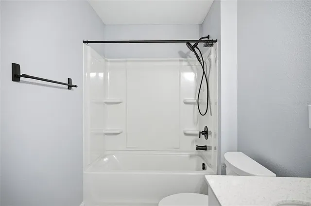 a bathroom with a shower and a bath tub