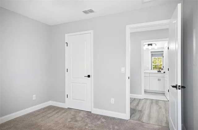 an empty room that has a wooden cupboard