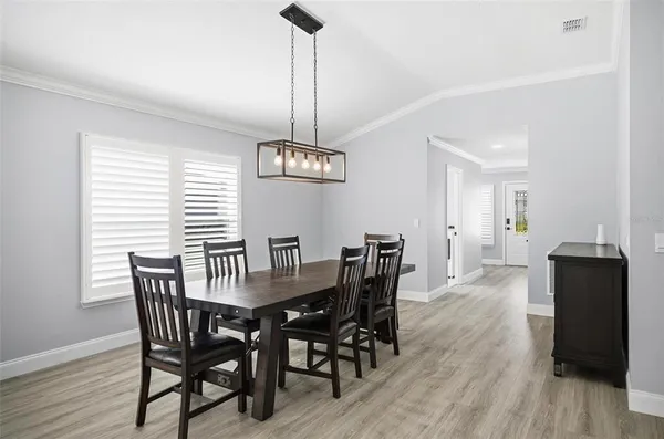 a view of a dining room with furniture window and wooden floor