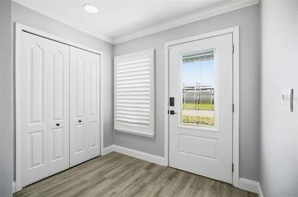 an empty room with windows and entryway