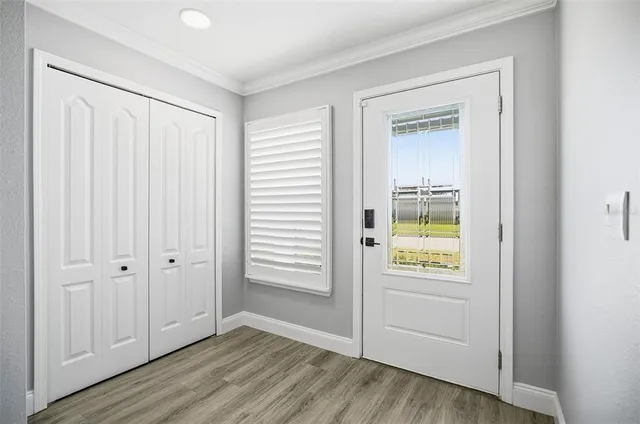 an empty room with windows and entryway