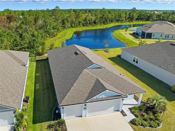 an aerial view of a house with pool ocean view