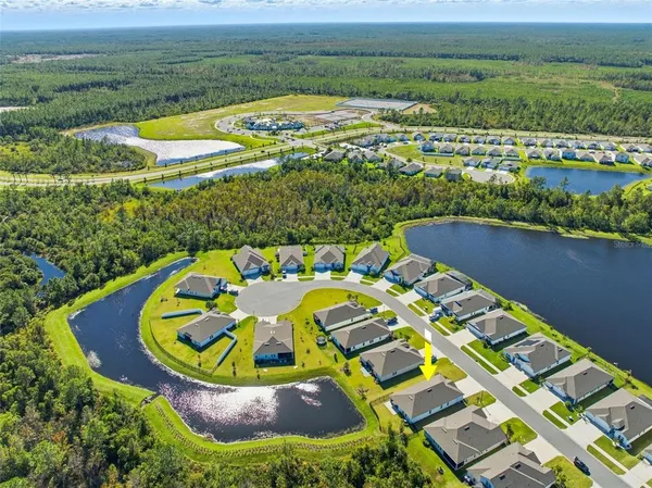 an aerial view of a house with a big yard