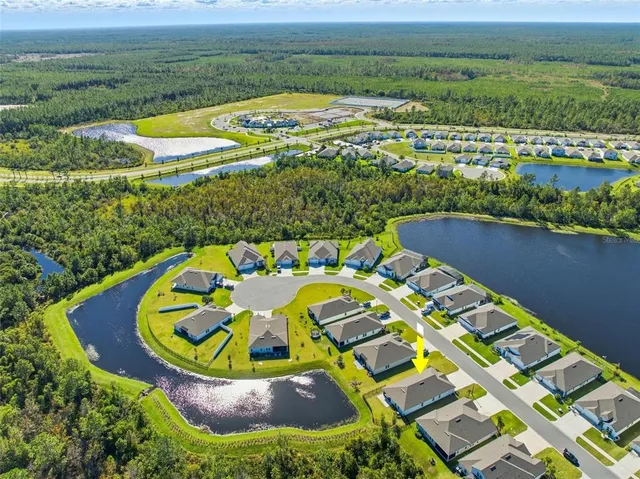 an aerial view of a house with a big yard