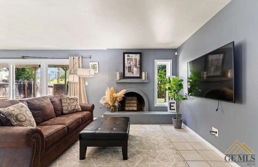 Undisclosed Address Bakersfield, CA 93309 - Photo 13 of 18 a living room with furniture a flat screen tv and a fireplace