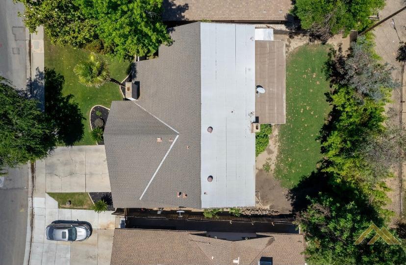 Undisclosed Address Bakersfield, CA 93309 - Photo 18 of 18 an aerial view of a house with a yard and large trees