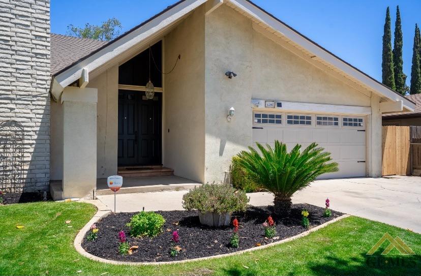 Undisclosed Address Bakersfield, CA 93309 - Photo 2 of 18 a front view of a house with a yard