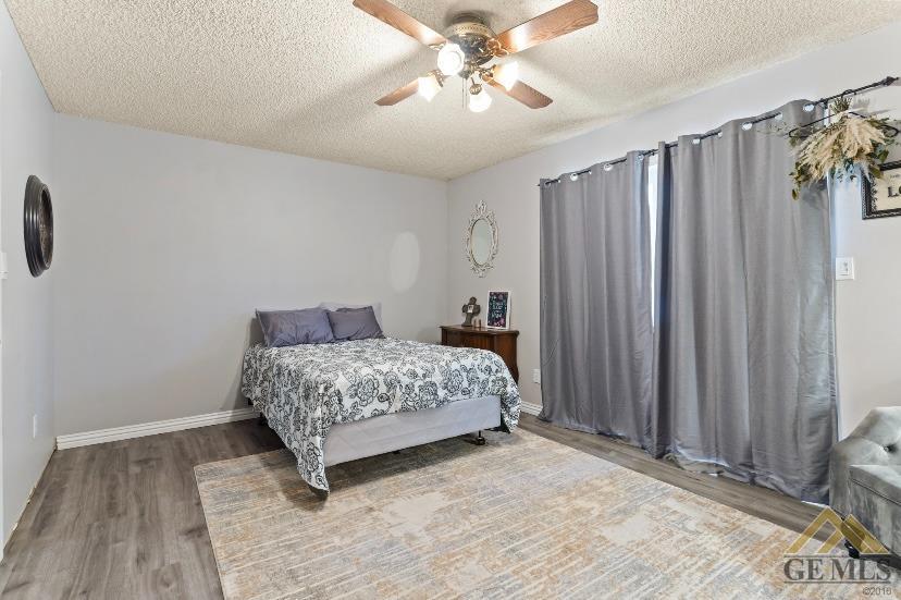 Undisclosed Address Bakersfield, CA 93309 - Photo 10 of 18 a bedroom with a bed and a chandelier