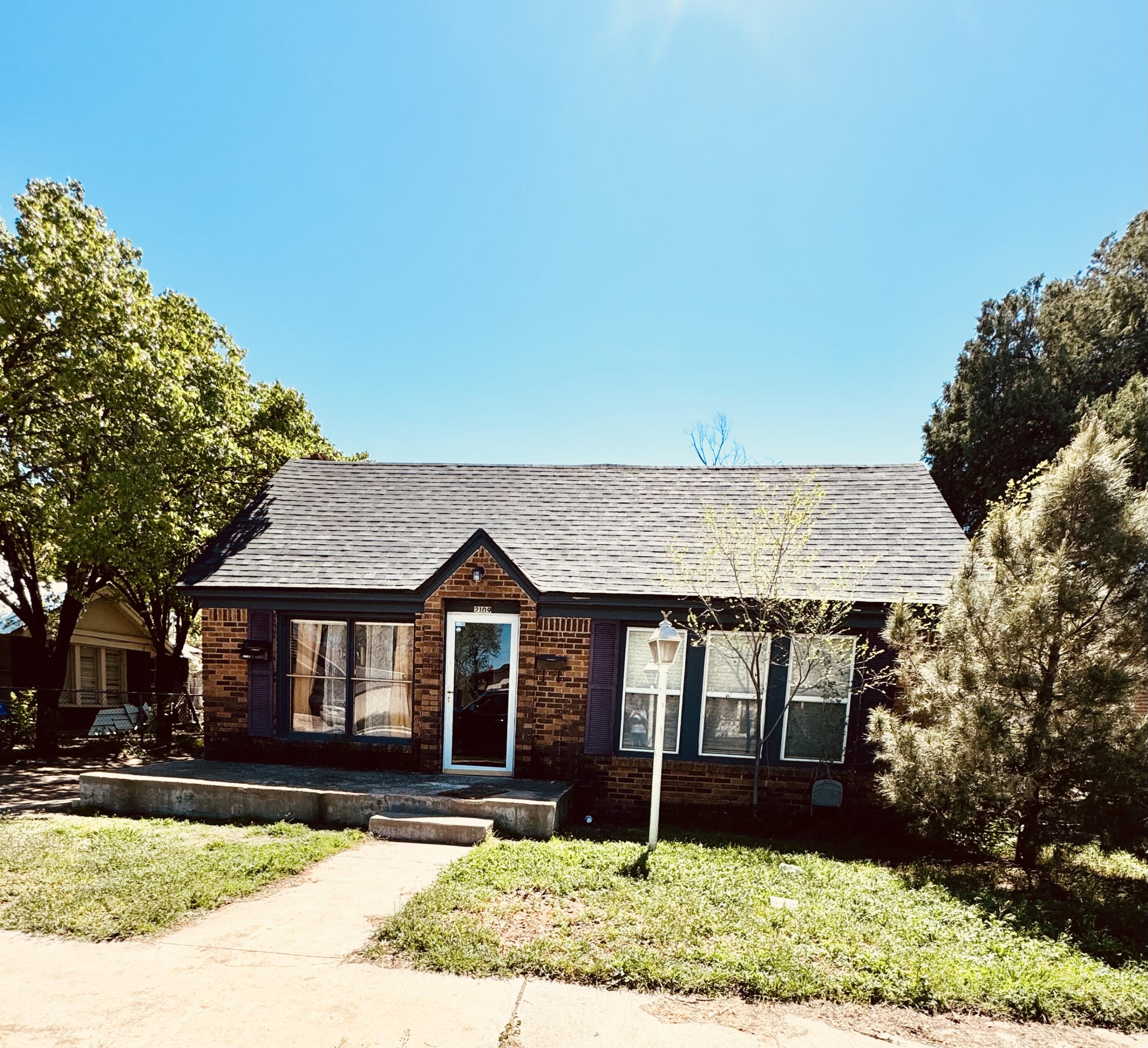 2109 22nd Street, Unit FRONT Lubbock, TX 79411 - Photo 1 of 16 a front view of a house with garden
