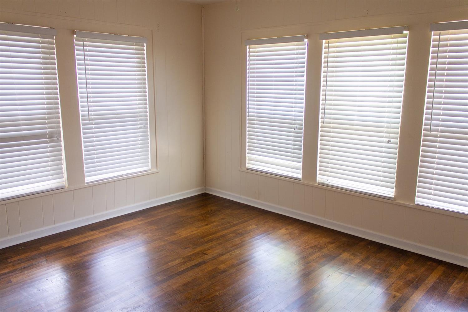 2109 22nd Street, Unit FRONT Lubbock, TX 79411 - Photo 13 of 16 a view of an empty room with wooden floor and a window