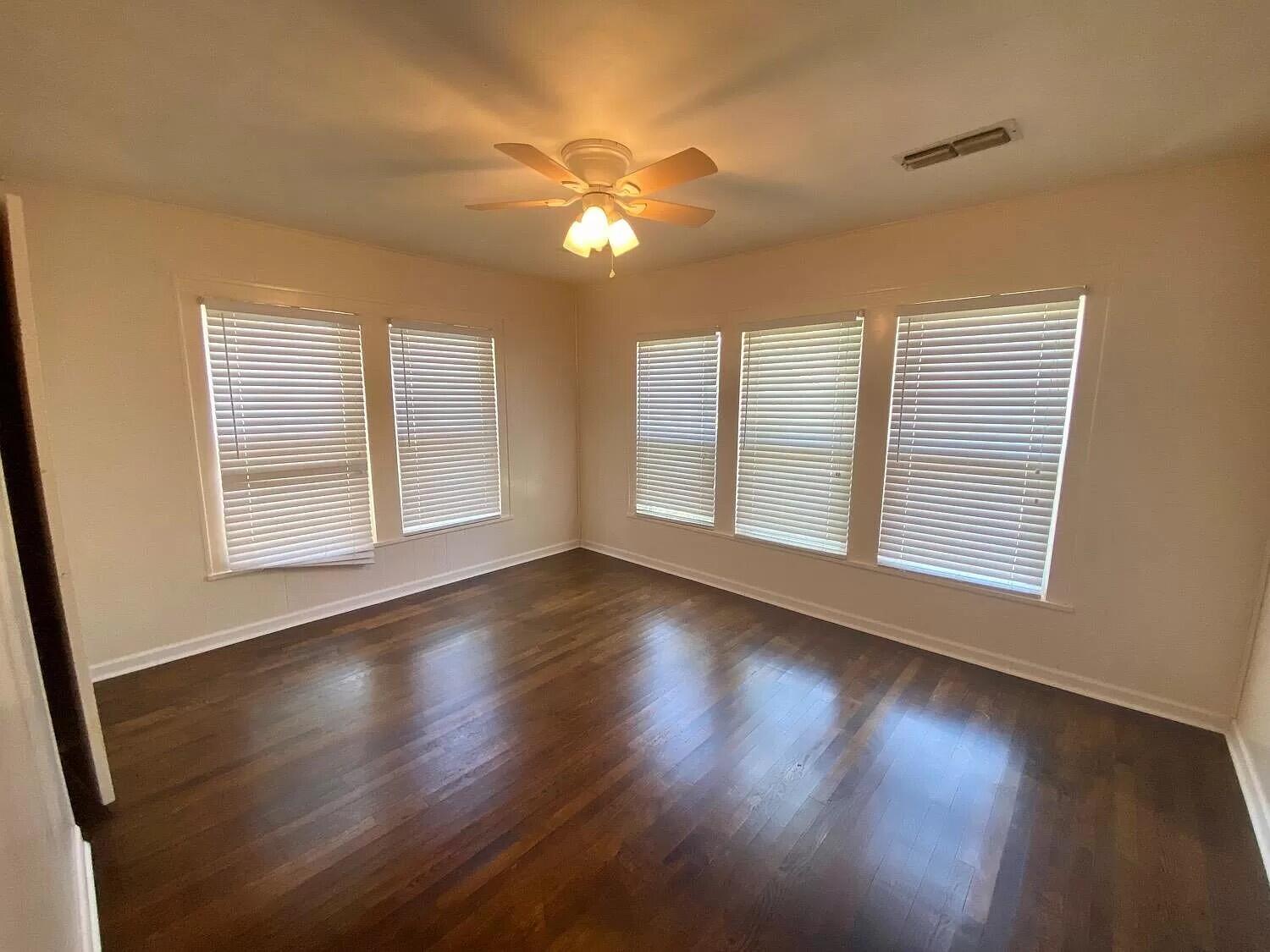 2109 22nd Street, Unit FRONT Lubbock, TX 79411 - Photo 15 of 16 a view of an empty room with wooden floor and a window